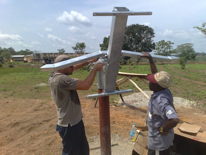 Engineers installing an antenna structure on site