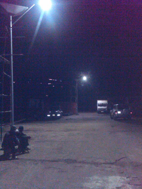 Solar-powered street light illuminating a road at night